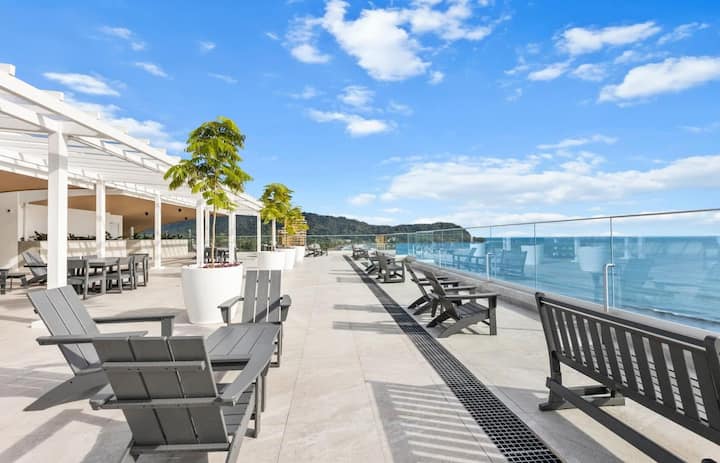 Rooftop deck overlooking the Pacific Ocean with Adirondack chairs